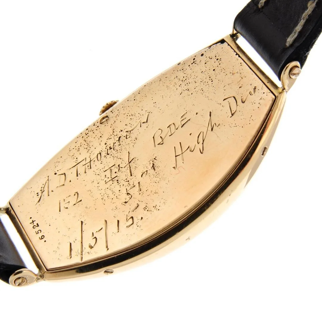 Gold watch case back with engraved inscription "A.D. Thomson 1st of High Div. 1/5/15".
