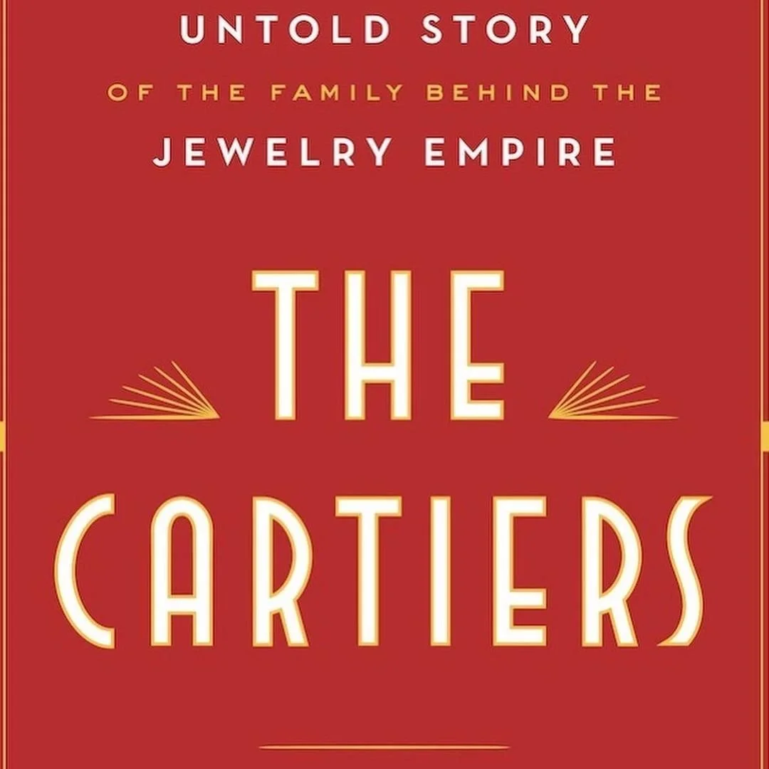 Red book cover with white and gold Art Deco typography for 'The Cartiers'.